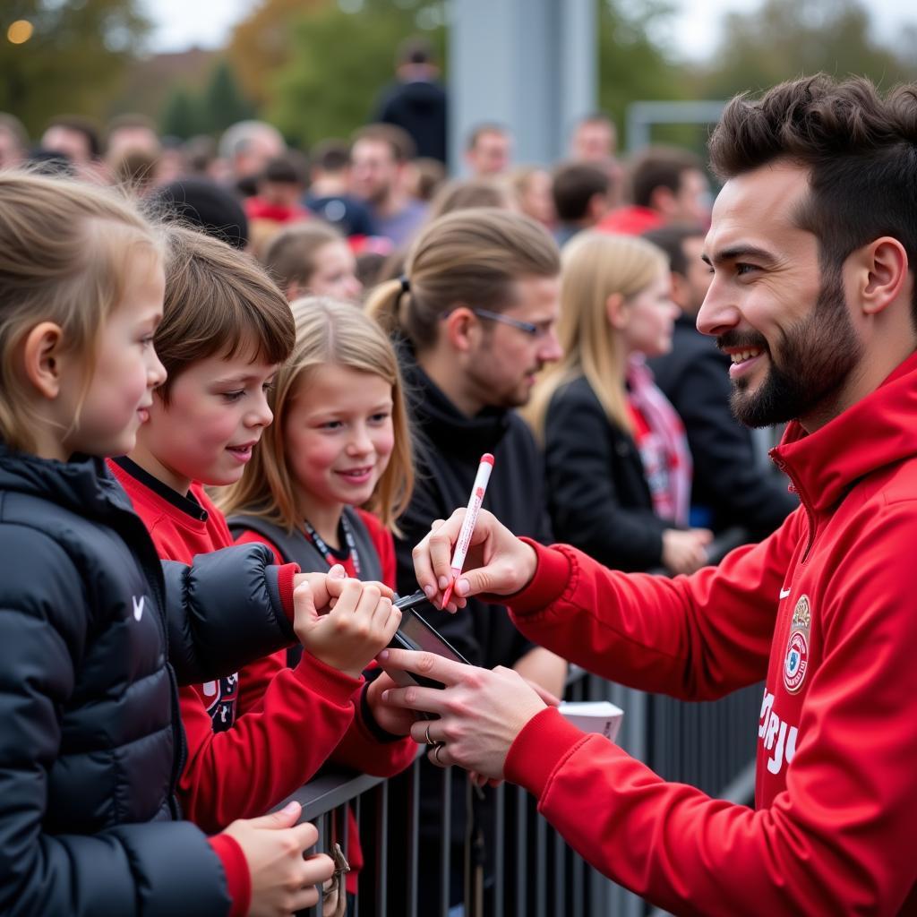 Fans feiern mit Bayer Leverkusen Spielern beim Familientag