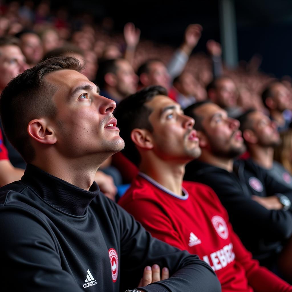 Bayer 04 Leverkusen fans watching match in pub