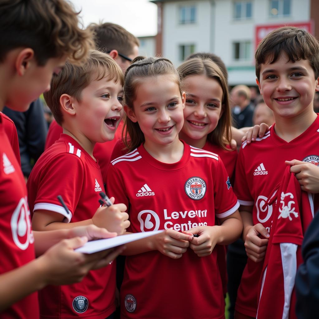 Kinder erhalten Autogramme von Bayer Leverkusen Spielern