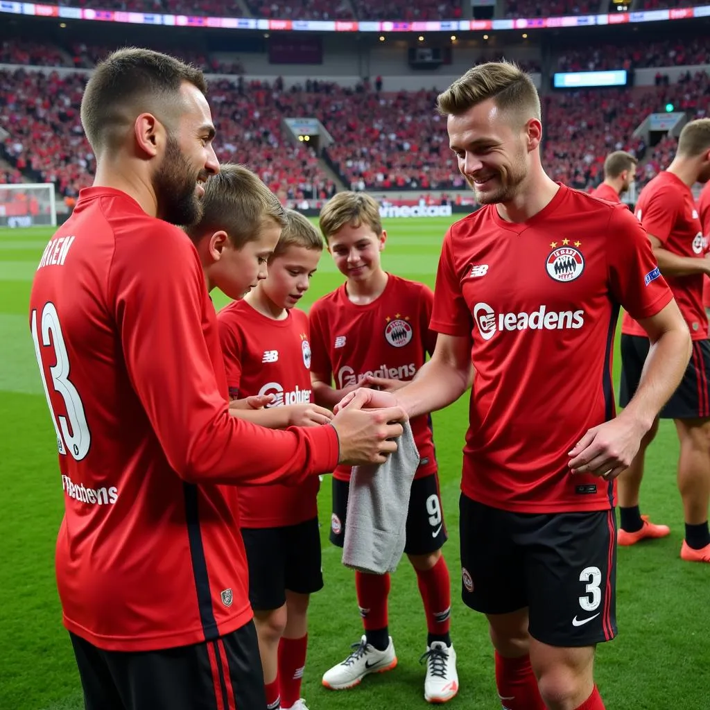 Spieler von Bayer Leverkusen interagieren mit jungen Fans