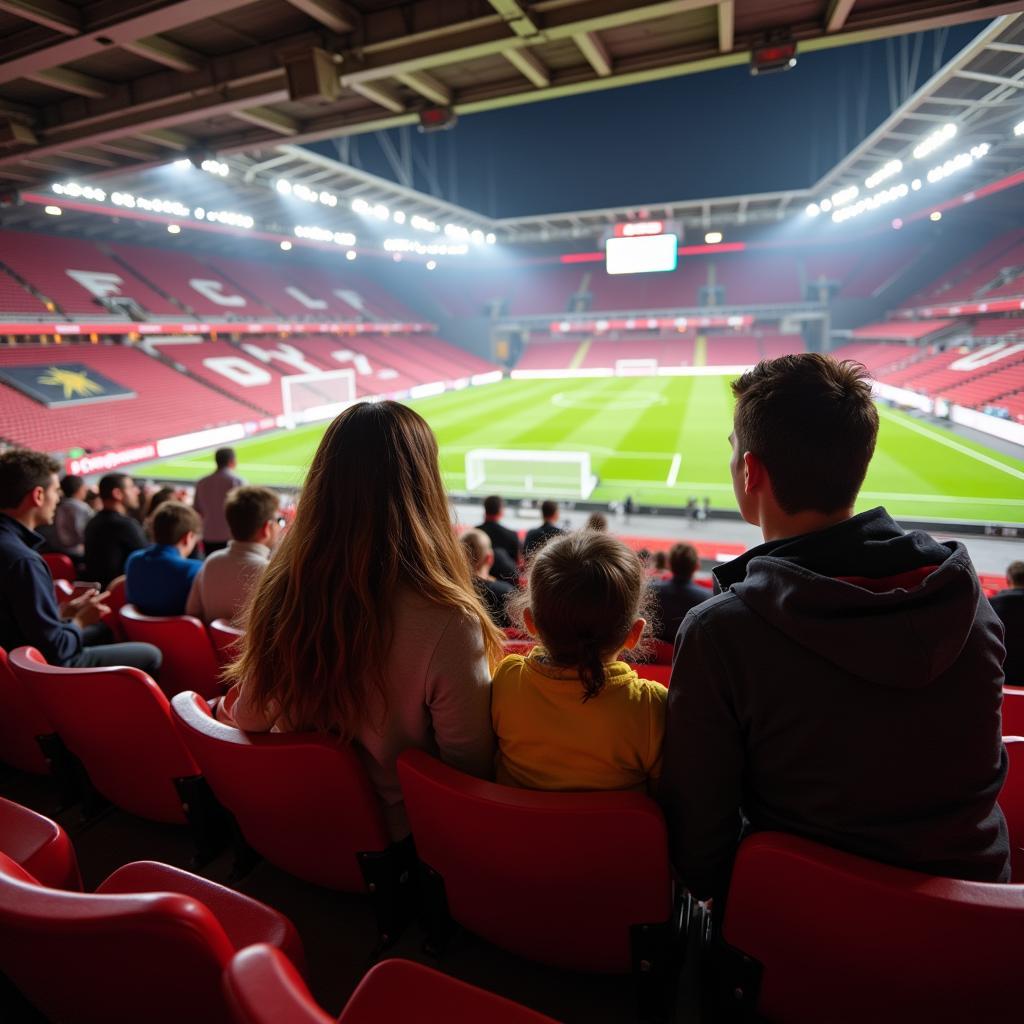 Eine Familie genießt einen mecz leverkusen in der BayArena