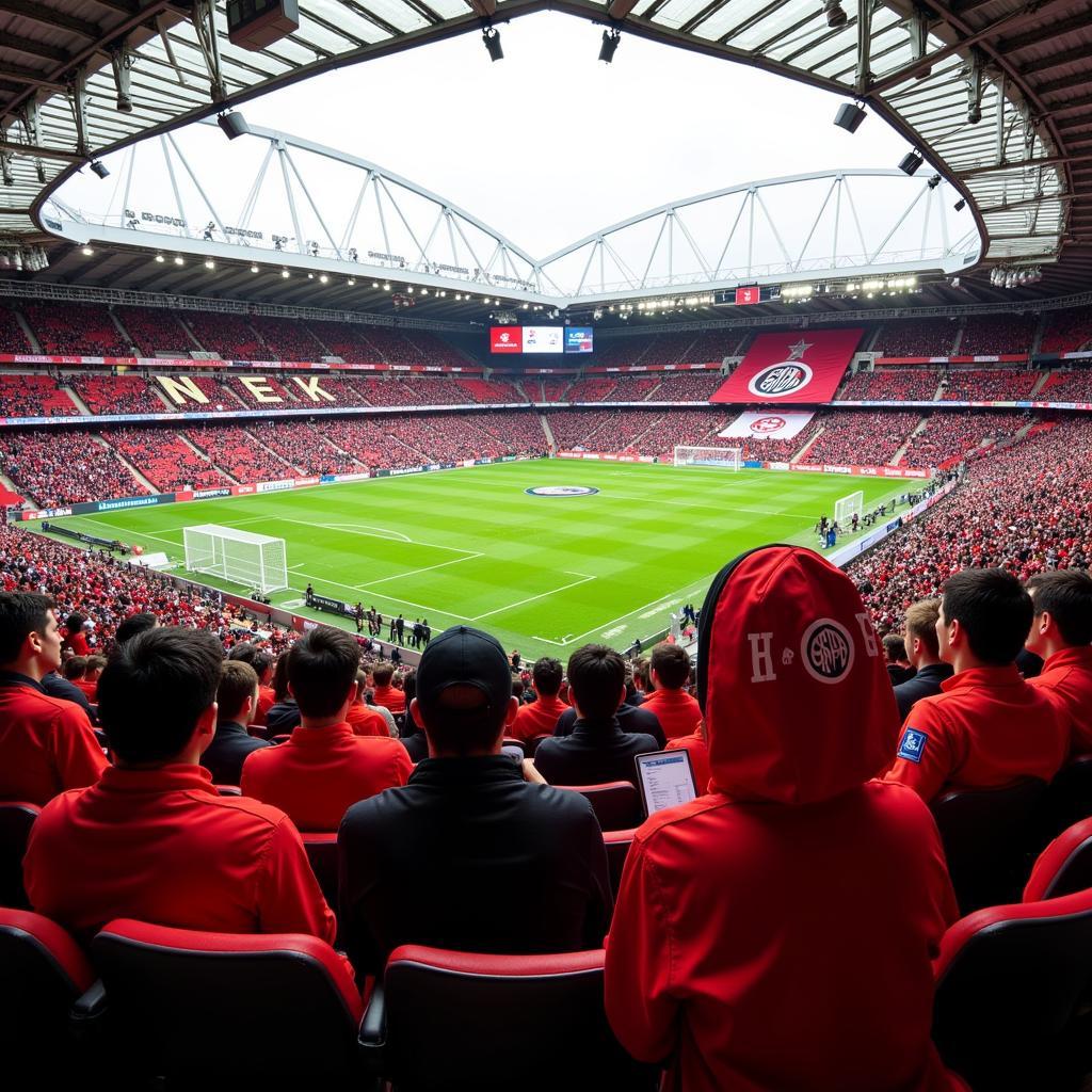 Fans mit Bayer Leverkusen Caps im Stadion