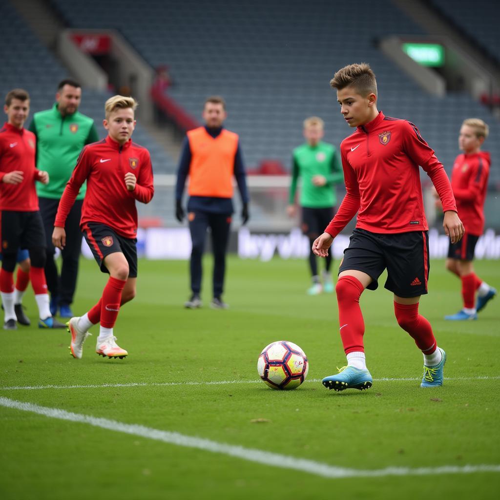 Junge Fußballer trainieren auf dem Gelände des Nachwuchsleistungszentrums von Bayer 04 Leverkusen.