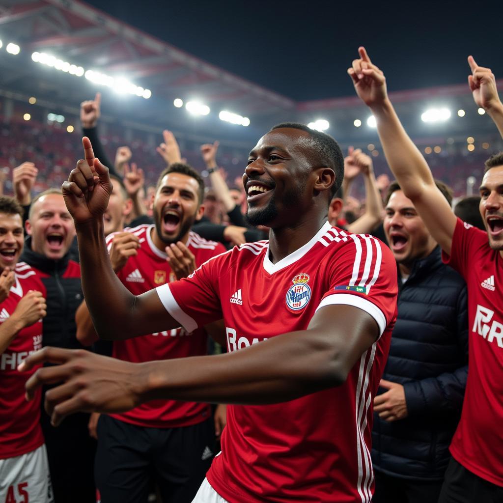 Odilon Kossounou feiert mit den Fans von Bayer Leverkusen nach einem Sieg in der BayArena.