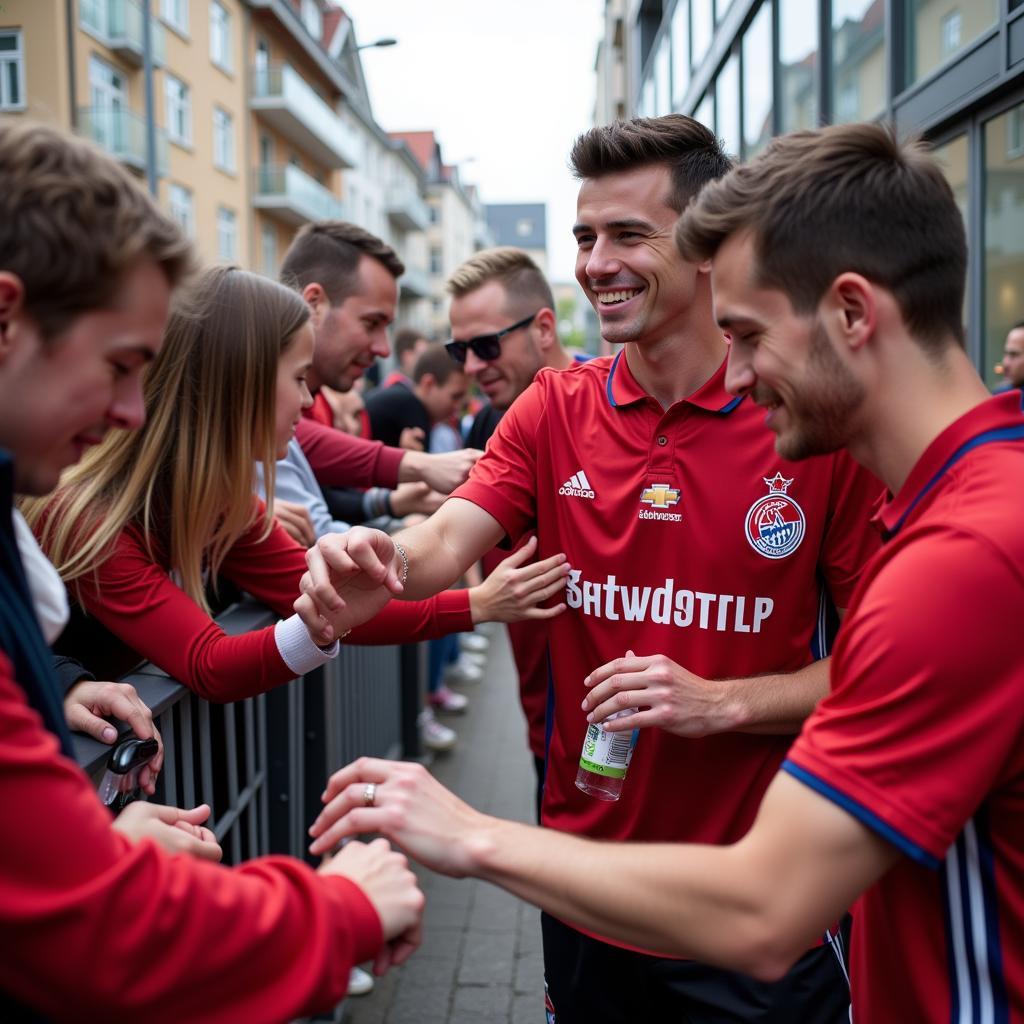 Spieler von Bayer Leverkusen feiern mit Fans auf der Adolfsstraße