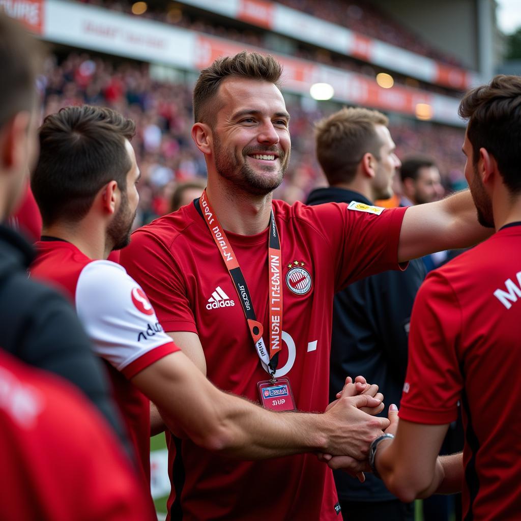 Tim Handwerker feiert mit den Fans von Bayer 04 Leverkusen