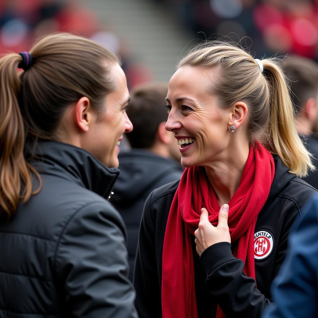 Astrid Büscher im Gespräch mit Fans von Bayer 04 Leverkusen.