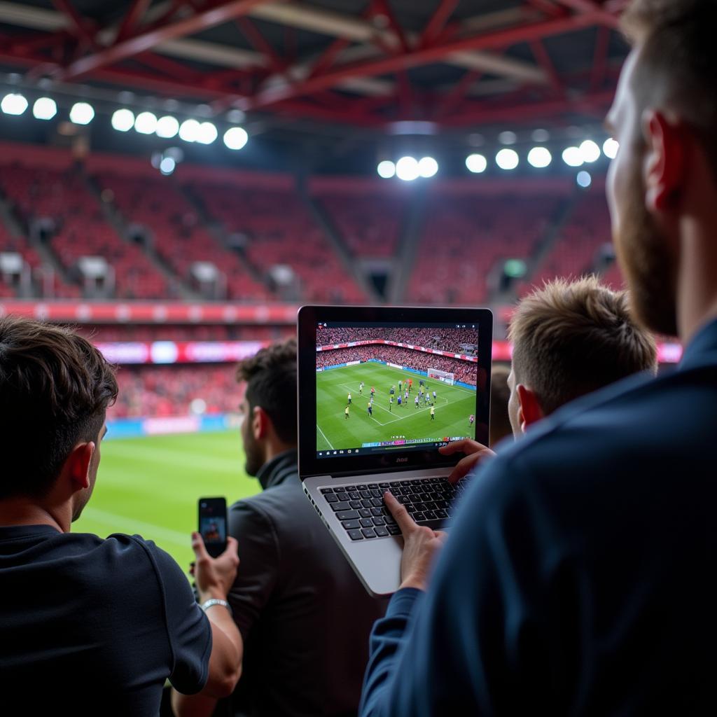 Fans interagieren während eines Live-Spiels von Bayer 04 Leverkusen auf Social Media Plattformen.