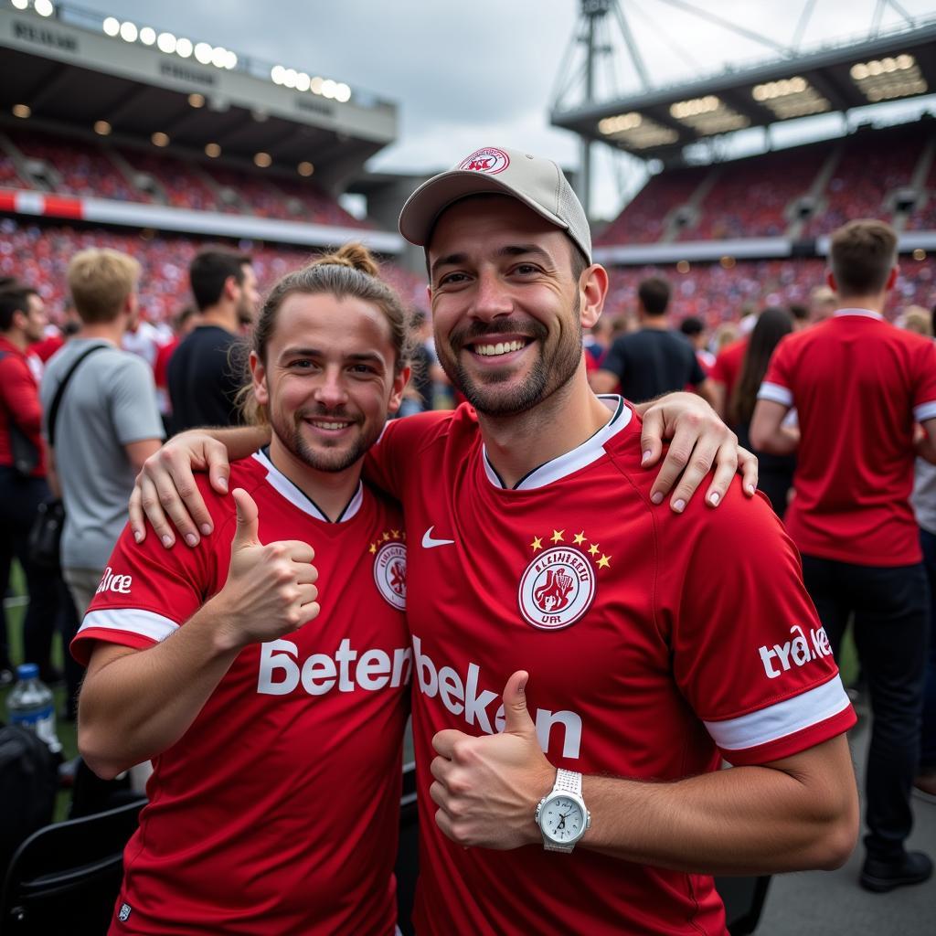 Fans im Stadion mit dem 2022-23 Bayer Leverkusen Away Shirt