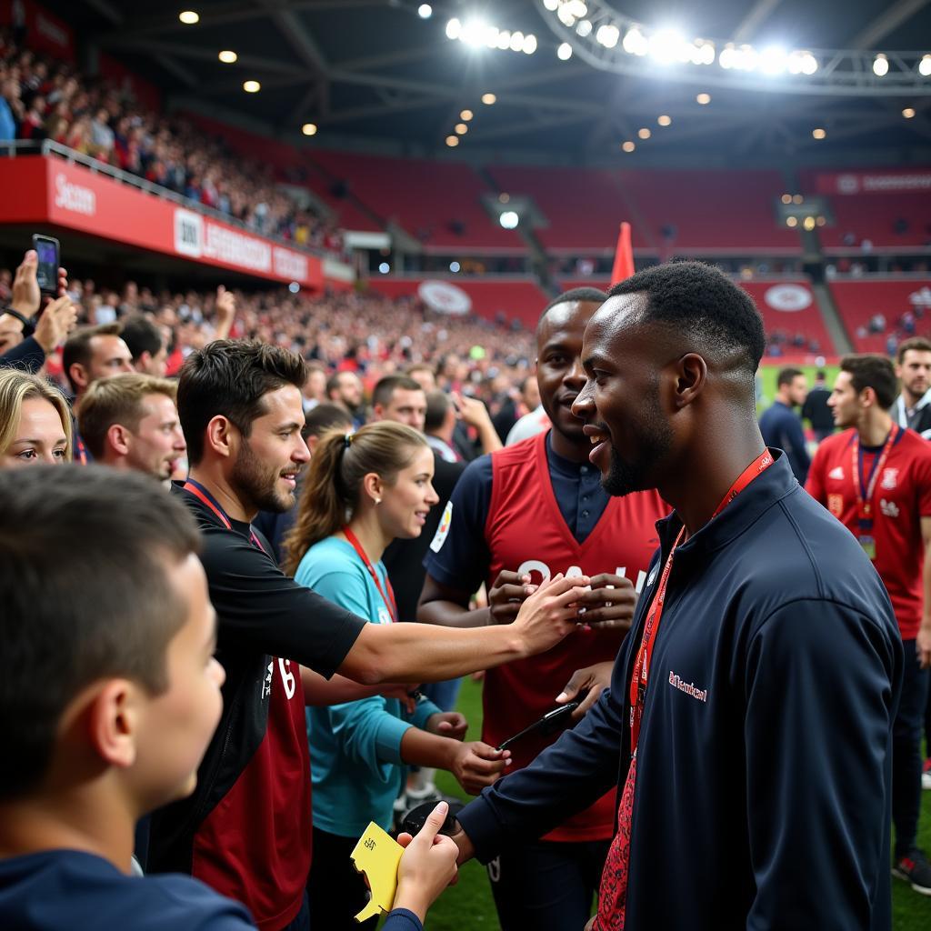 Victor Boniface mit Leverkusen Fans