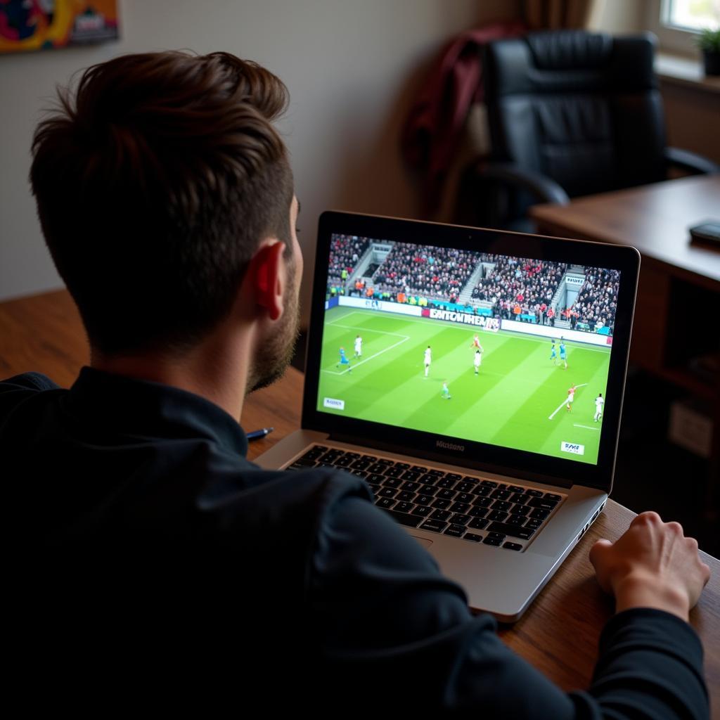 Live Stream Übertragung Bayern Leverkusen: Ein Fan schaut das Spiel auf seinem Laptop.