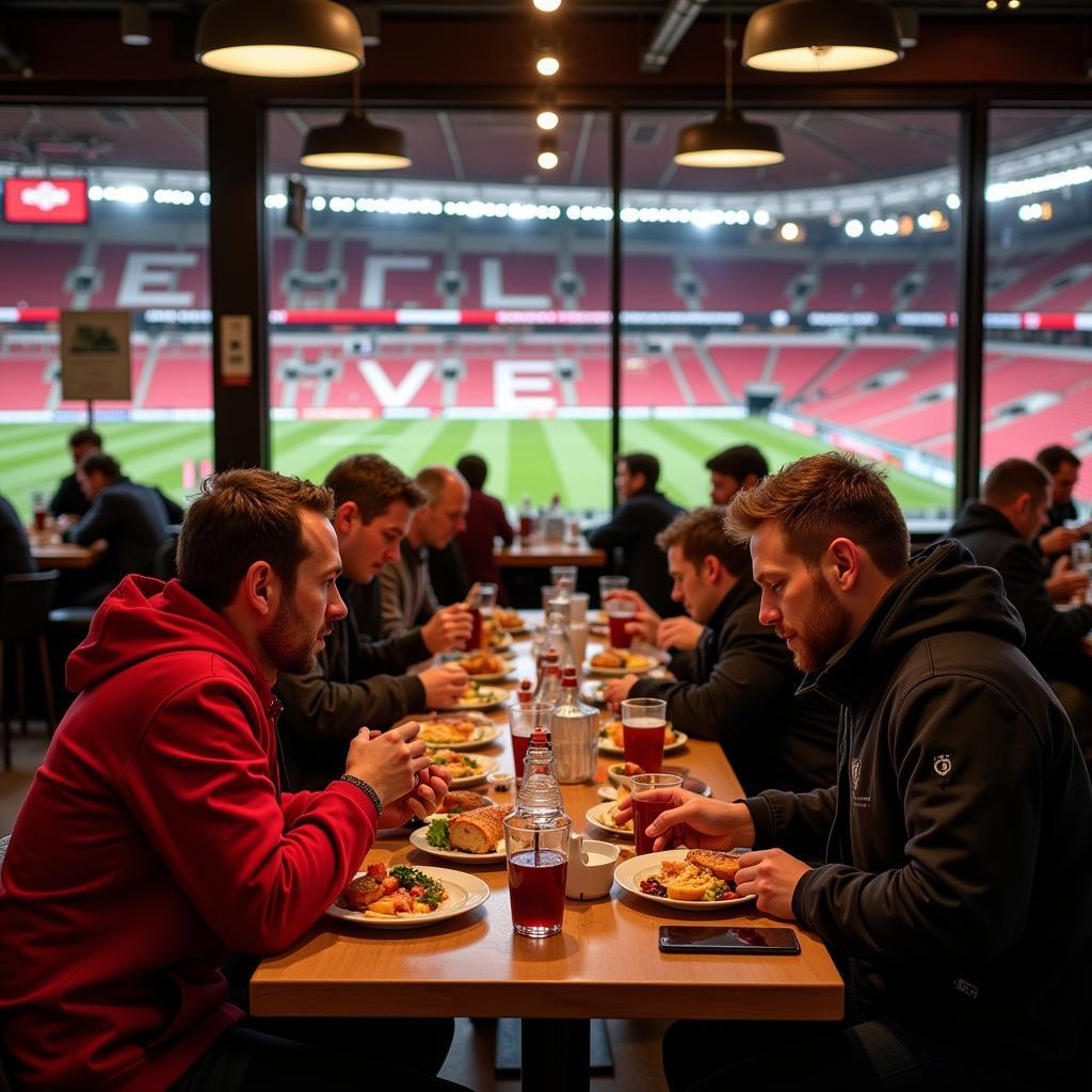 Restaurant in Stadionnähe Leverkusen Wiesdorf: Fans genießen Essen und Getränke vor dem Stadion.