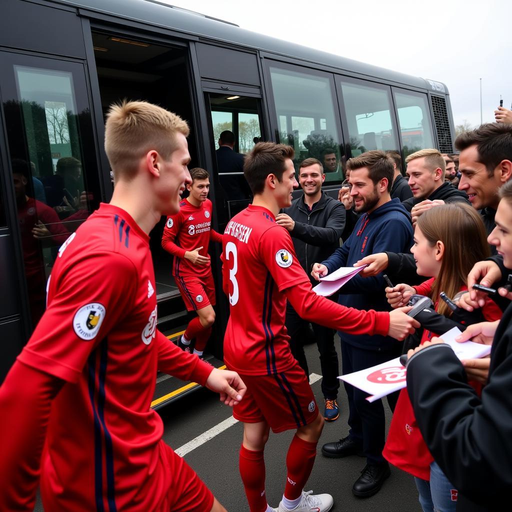 Die Spieler von Bayer Leverkusen steigen aus dem Mannschaftsbus aus und werden von den Fans begrüßt.