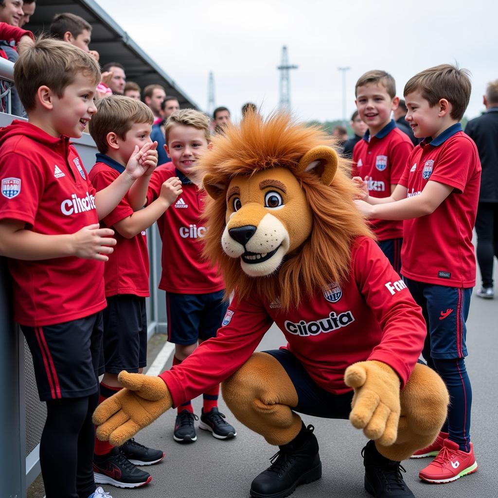 Brian the Lion posiert mit jungen Fans vor dem Spiel. Das Bayer Leverkusen Maskottchen ist bei den Jüngsten besonders beliebt.