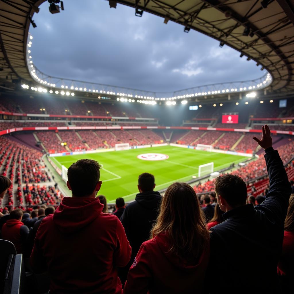 Fans feuern ihre Mannschaft im Stadion bei einem Spiel FC gegen Leverkusen an.